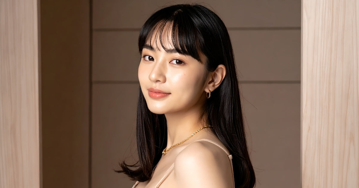 A young Asian model with long straight black hair and perfectly styled face-framing bangs that resist humidity.